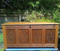 A 19th Century Hand carved Oak & Mahogany 4 Panelled Coffer With Original Key.